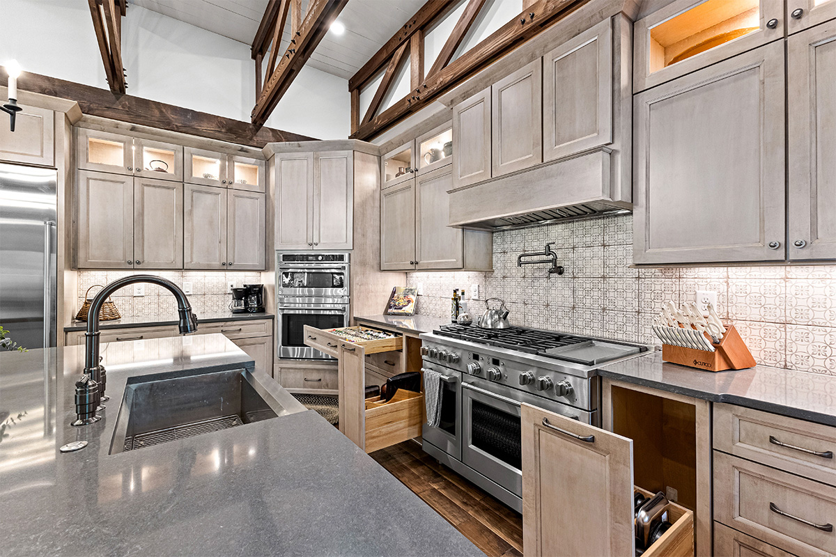 Light stained kitchen cabinets with exposed beams