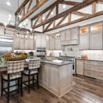 Light stained kitchen cabinets with exposed beams