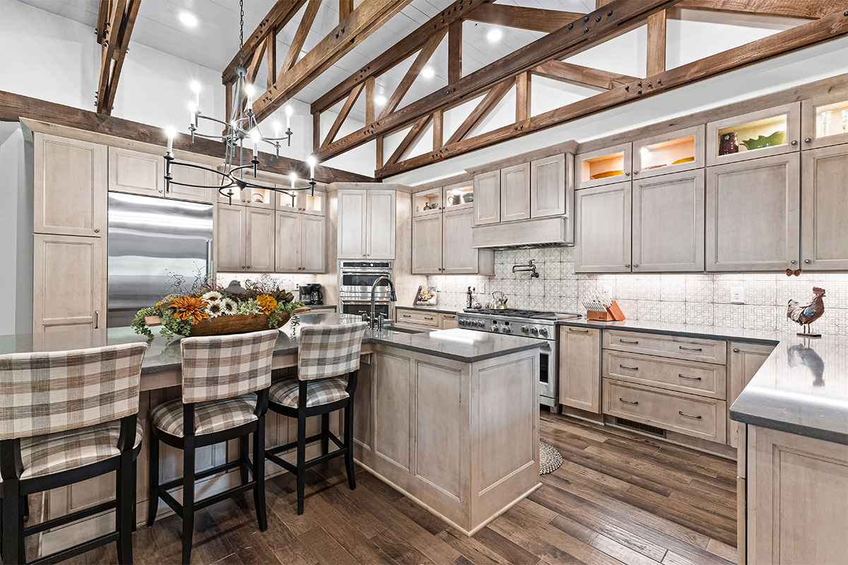 Light stained kitchen cabinets with exposed beams