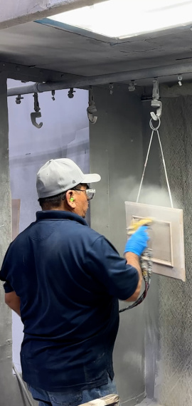 Man hand spraying a door