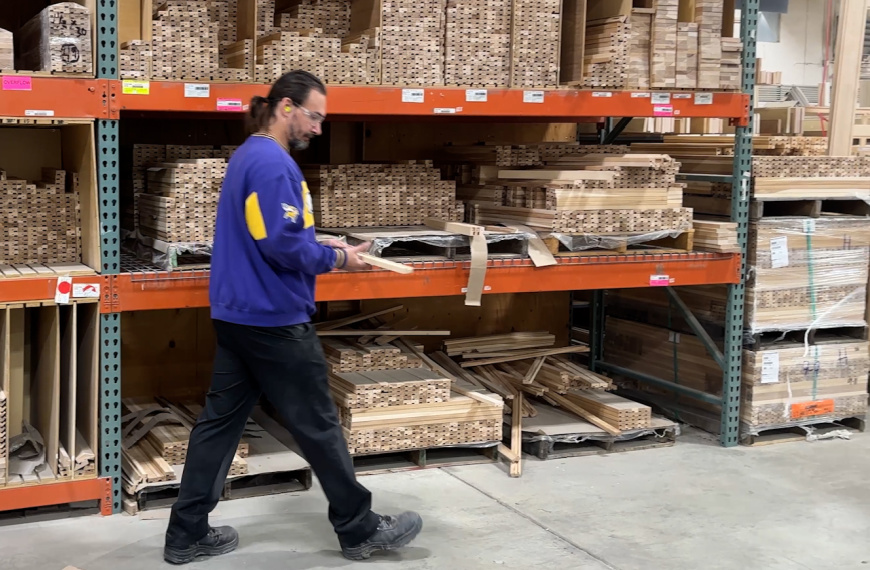 Man pulling cabinet frame part