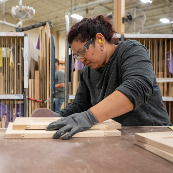 Woman sanding a door