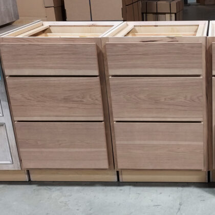 Two 3 drawer bases with slab drawer fronts in hickory finished with Sable stain.