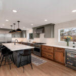 Painted gray and stained brown kitchen cabinets.