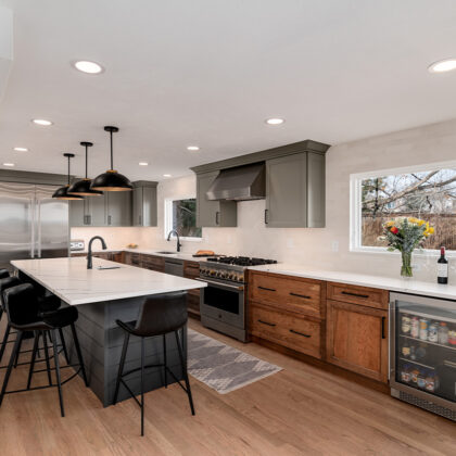 Painted gray and stained brown kitchen cabinets.