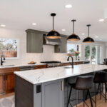 Painted gray and stained brown kitchen cabinets.