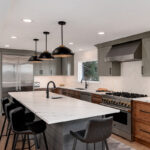 Painted gray and stained brown kitchen cabinets.