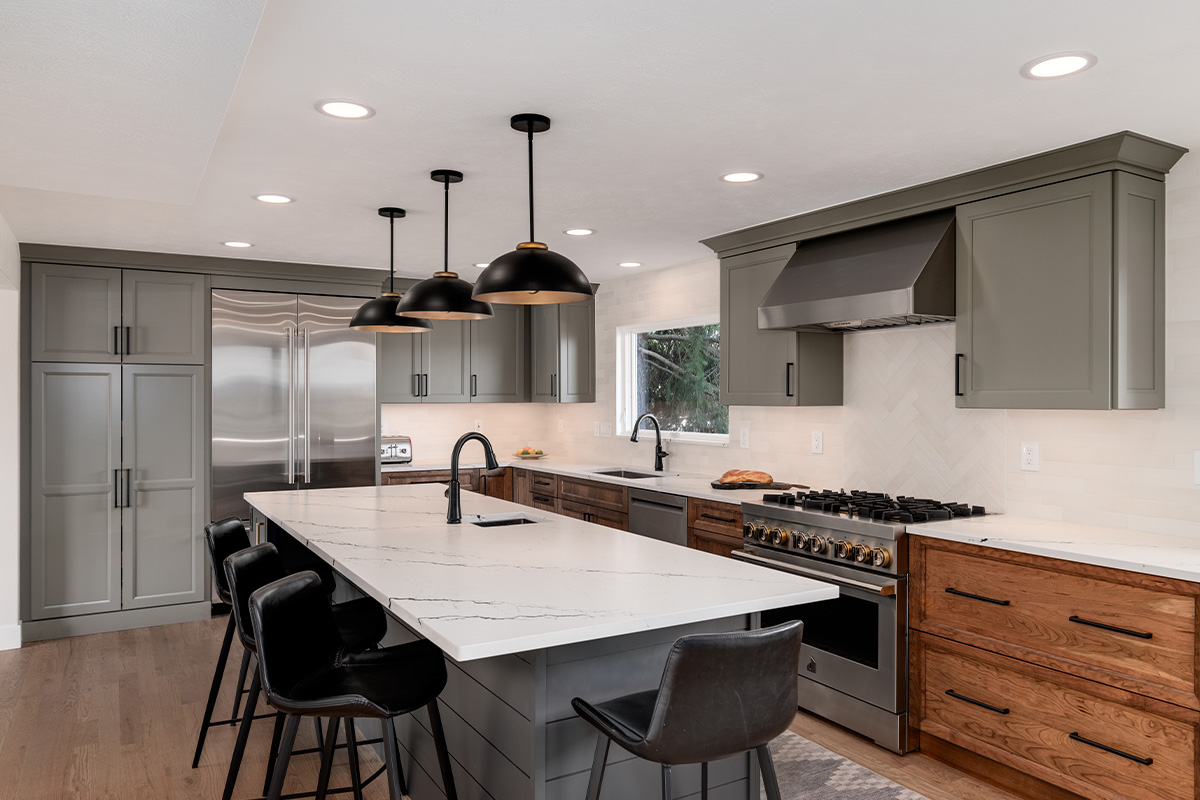 Painted gray and stained brown kitchen cabinets.