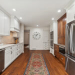 White kitchen with brown stained accent cabinets