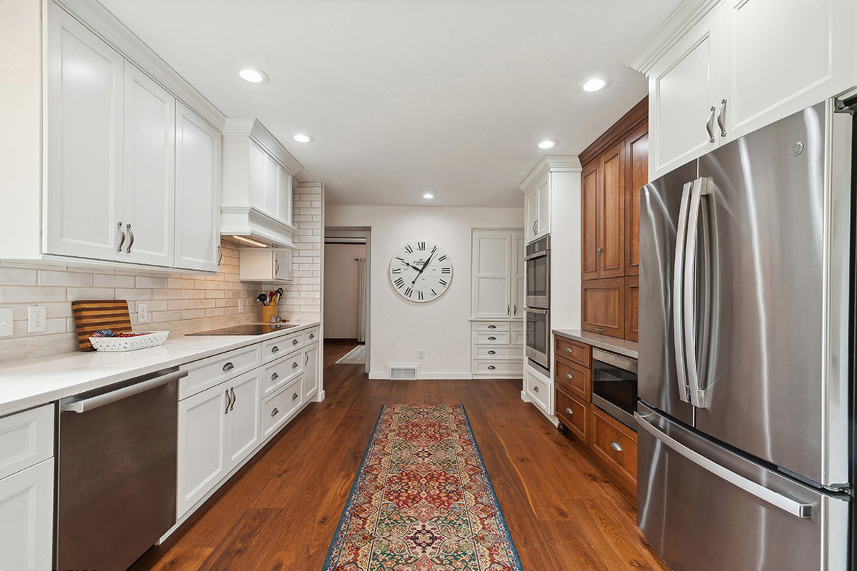 White kitchen with brown stained accent cabinets