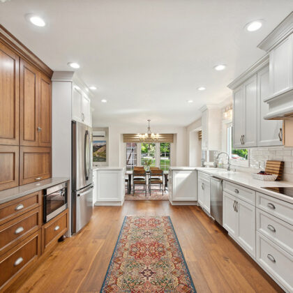 White kitchen with brown stained accent cabinets
