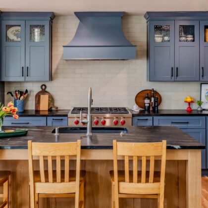 Blue painted kitchen with natural wood island