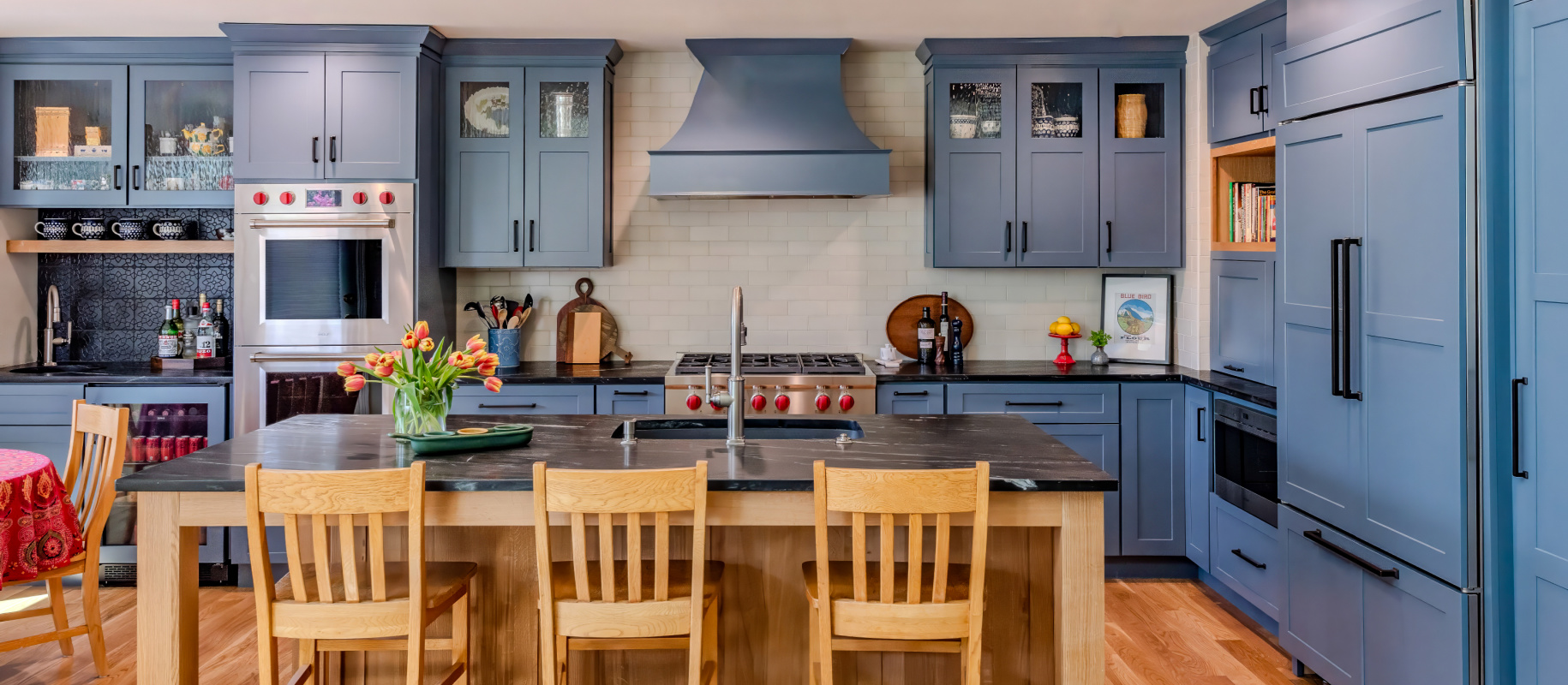 Blue painted kitchen with natural wood island