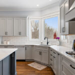 Painted gray kitchen cabinets and island.