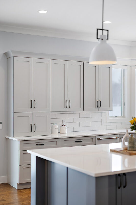 Painted gray kitchen cabinets and island.
