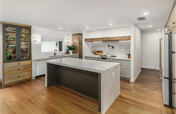 Multi-color kitchen with two-tone hutch, painted cabinets with stained accents.