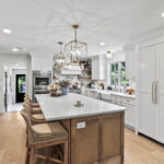 White kitchen with light brown stained island.