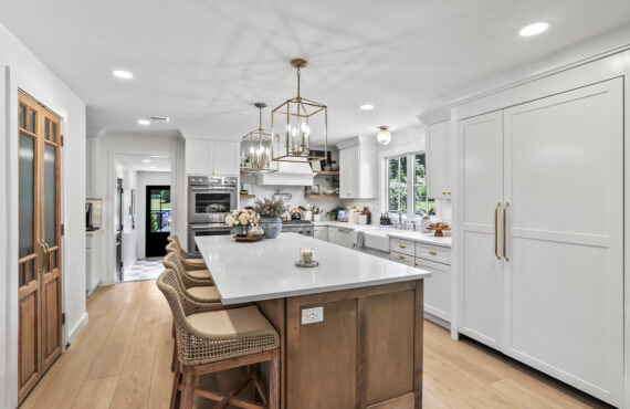 White kitchen with light brown stained island.