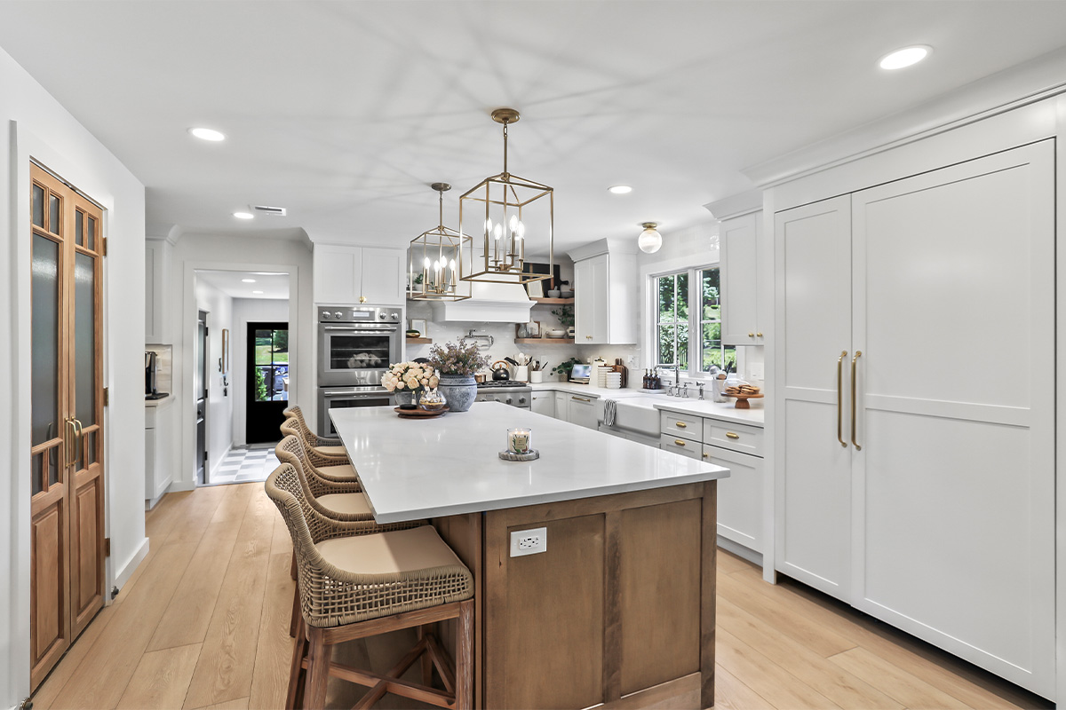 White kitchen with light brown stained island.