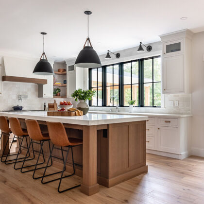 White painted perimeter and light brown stained island cabinets.