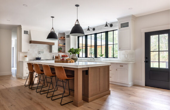 White painted perimeter and light brown stained island cabinets.