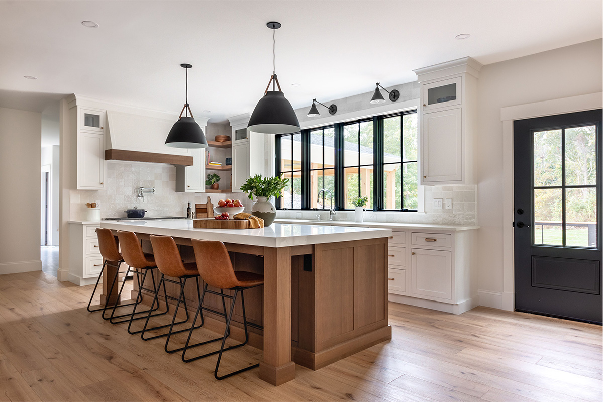 White painted perimeter and light brown stained island cabinets.