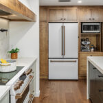 Multi-color kitchen with two-tone hutch, painted cabinets with stained accents.
