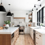 White painted perimeter and light brown stained island cabinets.