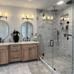 Master Bathroom with natural stained vanity and glass shower