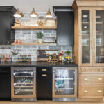 Dining room with black bar cabinets and light brown stained cabinet beside the bar.