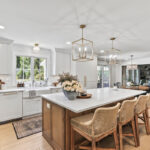 White kitchen with light brown stained island.