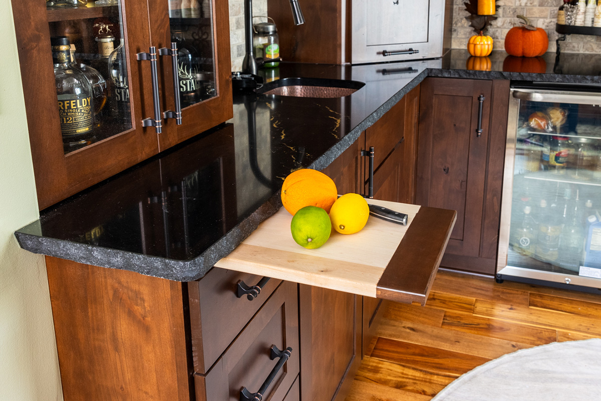 Cutting board extended out with lemon and a knife.