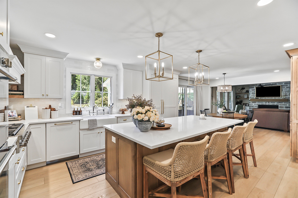 White kitchen with light brown stained island.