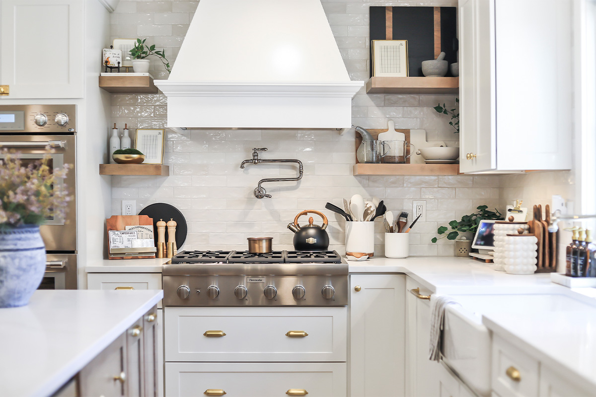 White kitchen with light brown stained island.