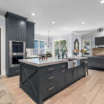 Light stained perimeter kitchen cabinets and Graphite painted island and hood.