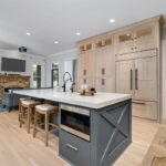Light stained perimeter kitchen cabinets and Graphite painted island and hood.