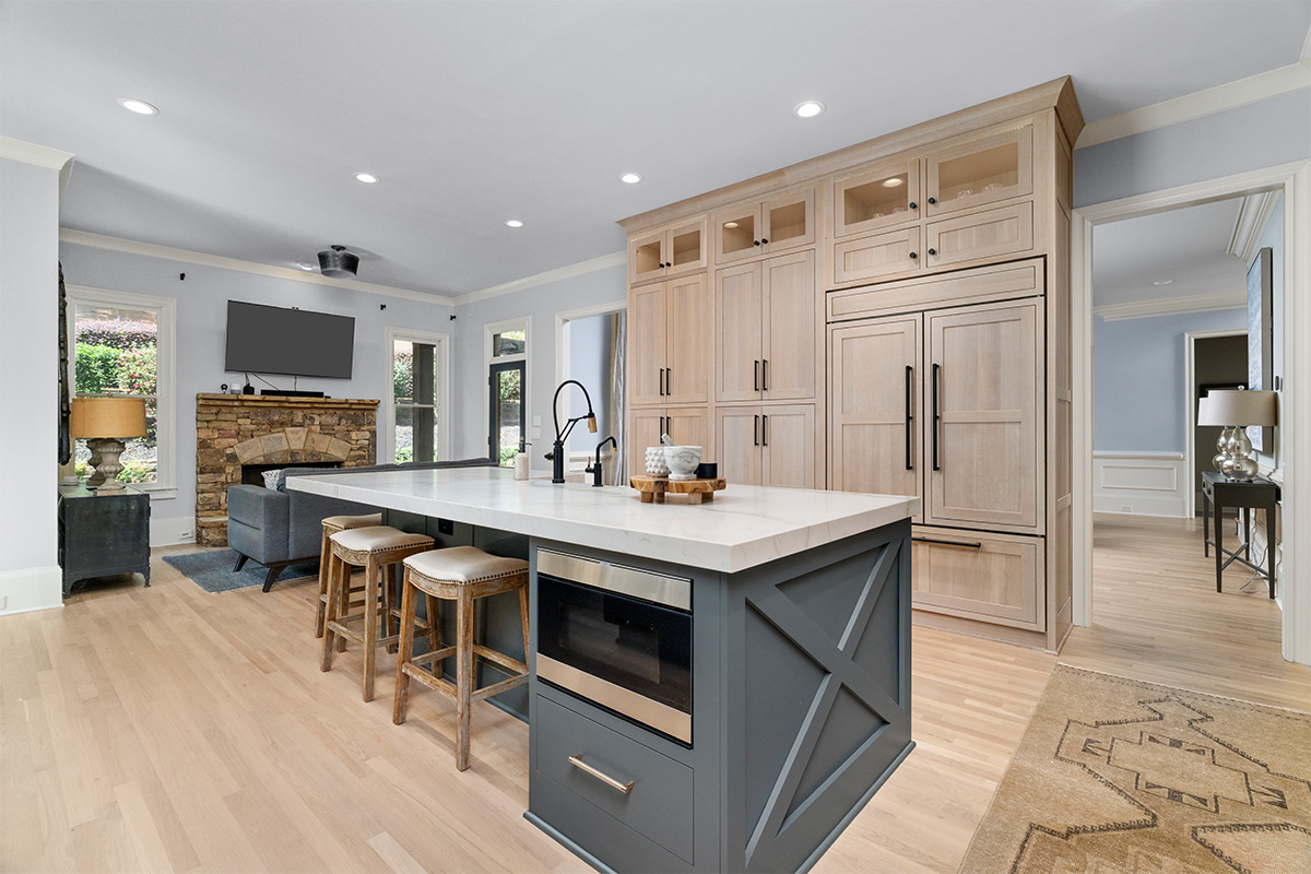Light stained perimeter kitchen cabinets and Graphite painted island and hood.