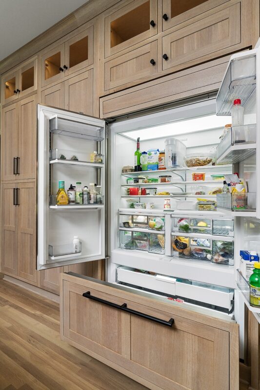 Light stained perimeter kitchen cabinets.