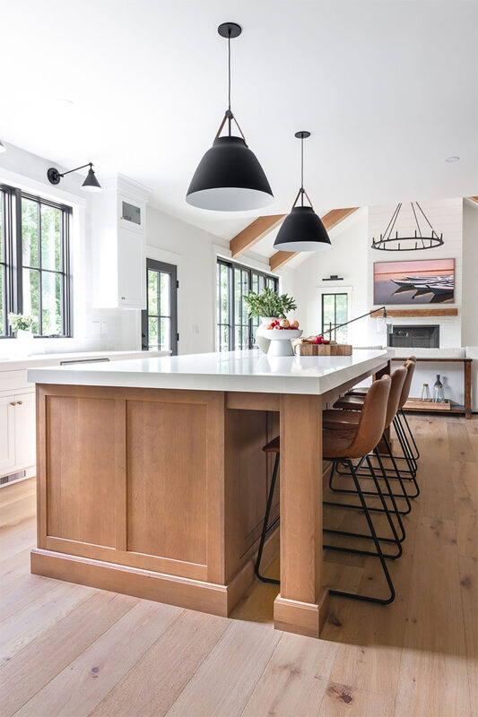 White painted perimeter and light brown stained island cabinets.