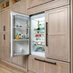 Light stained perimeter kitchen cabinets.