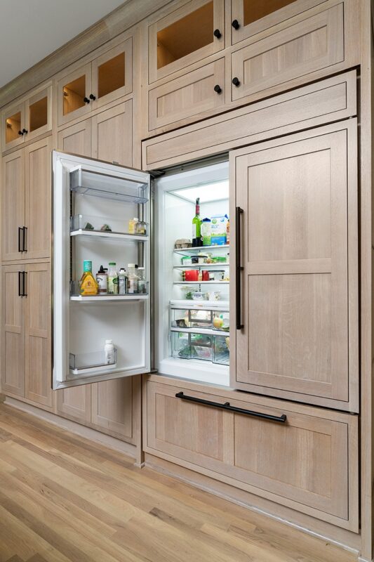 Light stained perimeter kitchen cabinets.