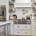 White kitchen with light brown stained island.