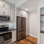 Painted Gun Smoke kitchen perimeter cabinets.