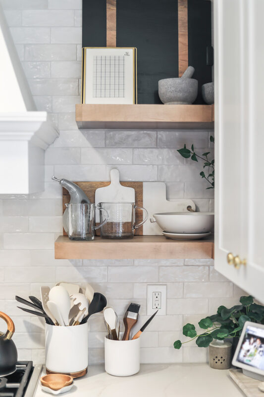 White cabinets with stained floating shelves