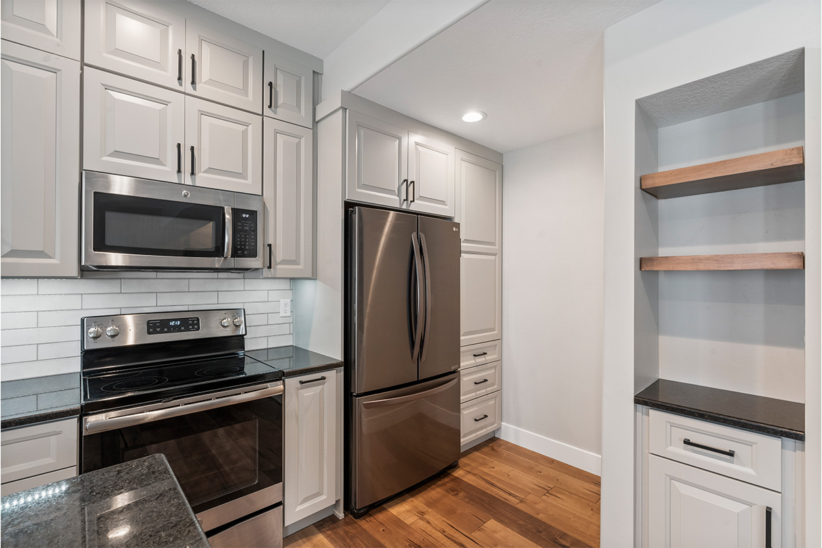 Painted Gun Smoke kitchen perimeter cabinets.