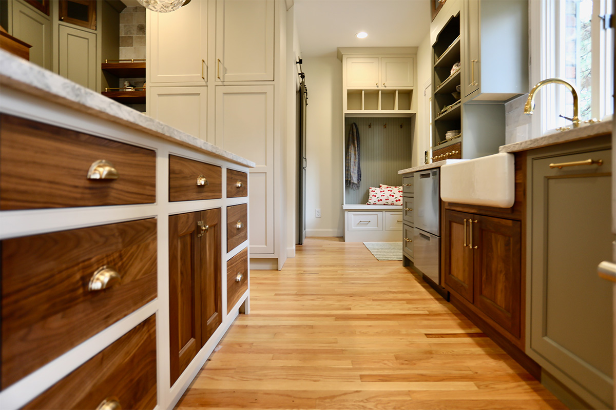 Kitchen island cabinets with painted frame and walnut natural drawer fronts and doors.