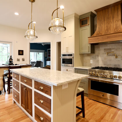 Painted cream and green kitchen cabinets.