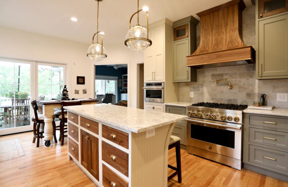 Painted cream and green kitchen cabinets.