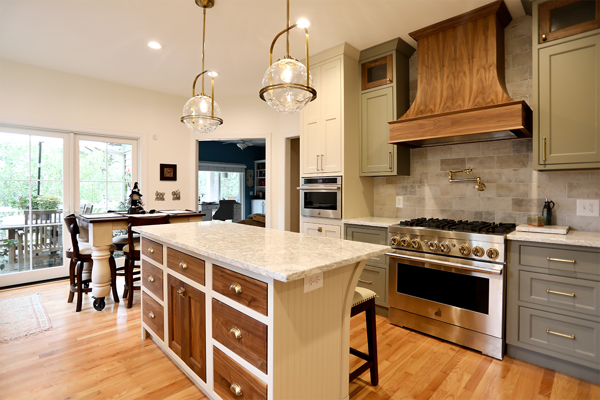 Painted cream and green kitchen cabinets.