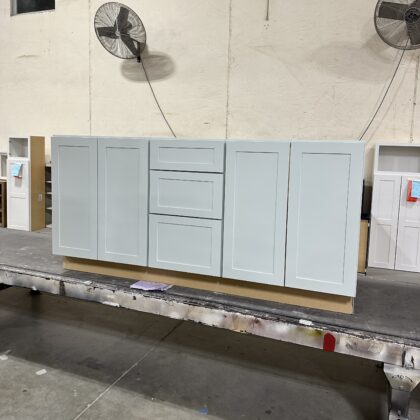 Vanity cabinet with 2 sets of doors and 3 drawers in the middle painted in Sea Salt